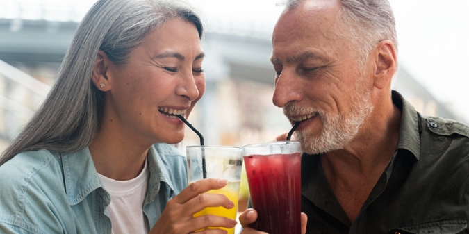 Mature couple enjoying drinks outdoors