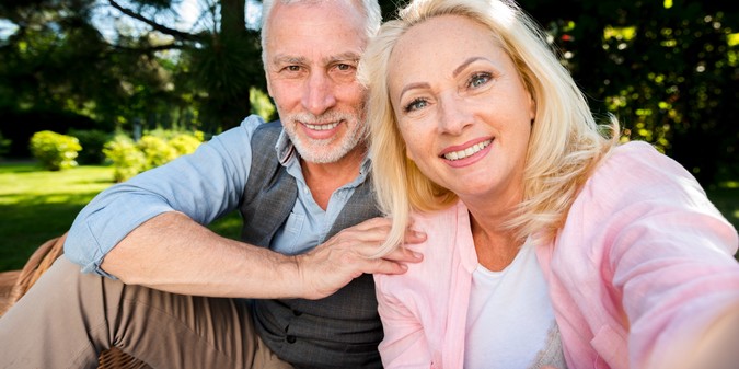 Smiling senior couple enjoying a picnic