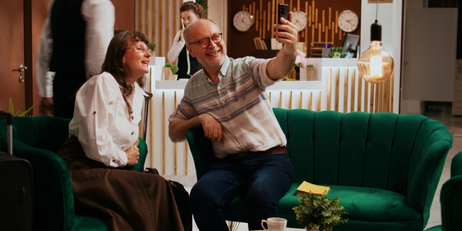 Mature couple taking a selfie in a lounge
