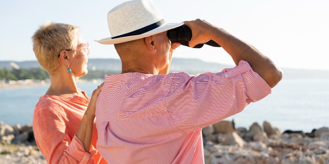 Older couple sightseeing by the sea