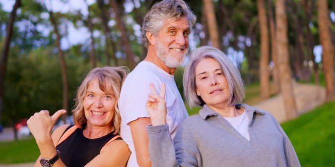 Three adults over 50 enjoying time together outdoors